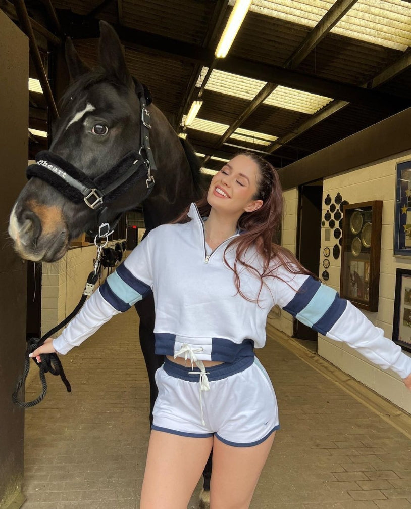 Populat equestrian influencer, Erin Williams, wearing the St Ives Cropper Quarter Zip and St Ives shorts with her horse.